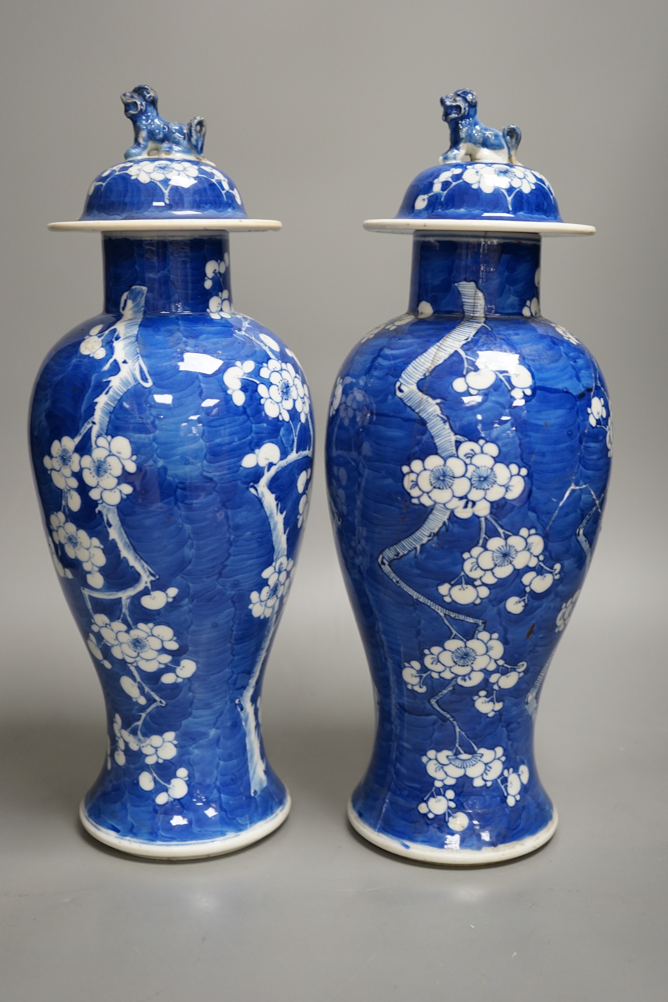 A pair of 19th century Chinese blue and white prunus vases, one a.f, 37cm